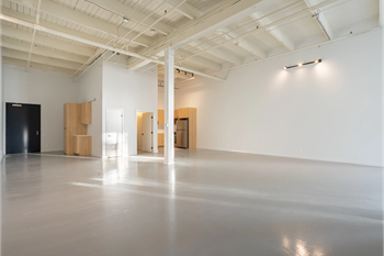 a large room with white walls and wood furniture in it